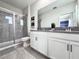 Bathroom featuring double sink vanity, modern fixtures, and walk-in shower at 1077 Leader St, Davenport, FL 33896