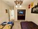 Charming bedroom with two twin beds, a TV, and unique overhead lighting at 1077 Leader St, Davenport, FL 33896