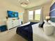 Comfortable bedroom featuring a plush bed, modern decor, and a wall-mounted television at 1077 Leader St, Davenport, FL 33896
