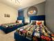 Themed bedroom with blue beds, Star Wars decor, and stylish accents at 1077 Leader St, Davenport, FL 33896