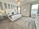 This bedroom features a modern chandelier, gray and white decor at 1077 Leader St, Davenport, FL 33896