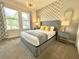 Stylish bedroom with large windows, neutral tones, and a king-sized bed with decorative pillows at 1077 Leader St, Davenport, FL 33896