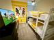 This bedroom is themed with a Mickey Mouse motif and features a bunk bed at 1077 Leader St, Davenport, FL 33896