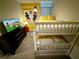 This bedroom is themed with a Mickey Mouse motif and features a bunk bed at 1077 Leader St, Davenport, FL 33896