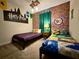 Whimsical bedroom with themed decor, two twin beds, and overhead lighting at 1077 Leader St, Davenport, FL 33896