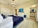 This well-decorated bedroom includes a TV, closet and ensuite bathroom at 1077 Leader St, Davenport, FL 33896