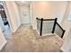 Hallway with carpet flooring and black iron railing leading to bedrooms at 1077 Leader St, Davenport, FL 33896