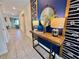 Inviting hallway with stylish decor elements, including a decorative table, lamps, and a round mirror at 1077 Leader St, Davenport, FL 33896