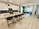 Open concept kitchen with an island, bar stool seating and modern stainless steel appliances at 1077 Leader St, Davenport, FL 33896