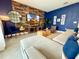 Cozy living room showcasing a plush sectional sofa, a rustic wood accent wall, and stylish decor at 1077 Leader St, Davenport, FL 33896