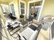 Outdoor patio with comfortable seating, grill, and view of the backyard at 1077 Leader St, Davenport, FL 33896