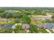 Aerial view showcasing the property's location within a lush, green neighborhood with a nearby lake at 11 Huntley Ct, Haines City, FL 33844