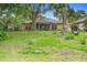 Lush backyard with mature trees creating a serene setting, perfect for outdoor enjoyment and relaxation at 11 Huntley Ct, Haines City, FL 33844