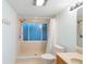 Bathroom featuring a large window and a shower with curtain at 11 Huntley Ct, Haines City, FL 33844