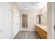 Bathroom features double sinks, wood cabinets, toilet room, and plenty of storage at 11 Huntley Ct, Haines City, FL 33844