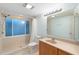 Bathroom with updated vanity, toilet, and walk-in shower with privacy window at 11 Huntley Ct, Haines City, FL 33844