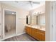 Bright bathroom features a double sink vanity, wood-look floors, and a separate toilet area at 11 Huntley Ct, Haines City, FL 33844