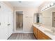 Bright bathroom boasts a double sink vanity, wood-look floors, and a separate toilet area at 11 Huntley Ct, Haines City, FL 33844