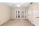 Bedroom featuring a ceiling fan, closet and French doors to the patio at 11 Huntley Ct, Haines City, FL 33844