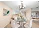 Elegant dining room featuring a round glass table, seating for six, and views of the kitchen at 11 Huntley Ct, Haines City, FL 33844