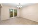 Cozy dining room with a large window and elegant chandelier at 11 Huntley Ct, Haines City, FL 33844