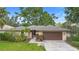 Charming single-story home with a well-maintained lawn, mature landscaping, and a two-car garage at 11 Huntley Ct, Haines City, FL 33844
