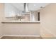 Well-designed kitchen with white cabinets, stainless steel hood, and tile flooring at 11 Huntley Ct, Haines City, FL 33844