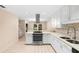 Modern kitchen featuring stainless steel appliances, white cabinets, and a breakfast bar at 11 Huntley Ct, Haines City, FL 33844