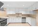 Well-lit kitchen with white cabinetry, stainless steel appliances, and ample counter space at 11 Huntley Ct, Haines City, FL 33844