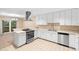 Bright kitchen featuring white cabinets, stainless steel appliances, and stylish backsplash at 11 Huntley Ct, Haines City, FL 33844
