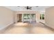 Spacious living room with neutral carpet, large sliding doors, and easy access to the outdoors at 11 Huntley Ct, Haines City, FL 33844