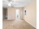 Neutral living room with ceiling fan, carpet flooring, and access to other rooms at 11 Huntley Ct, Haines City, FL 33844