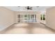 Open and airy living area with large sliding doors, neutral carpet, and an abundance of natural light at 11 Huntley Ct, Haines City, FL 33844