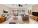 Bright and inviting living room with neutral tones, comfortable seating, and sliding doors to the outdoors at 11 Huntley Ct, Haines City, FL 33844