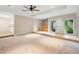 Bright living room featuring a ceiling fan, neutral walls, and entrance to the kitchen at 11 Huntley Ct, Haines City, FL 33844