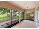 Screened patio with views of the landscaped yard and mature tree at 11 Huntley Ct, Haines City, FL 33844
