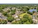 Aerial view features lush landscaping, neighborhood, and small pond at 1301 Paradise Ln, Winter Park, FL 32792