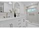 Elegant bathroom features double vanity, gold fixtures, a shower, and stylish decor at 1301 Paradise Ln, Winter Park, FL 32792