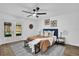 Cozy bedroom with a ceiling fan, a patterned rug, and doors leading to the outside at 1301 Paradise Ln, Winter Park, FL 32792