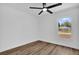 Well-lit bedroom boasts wood floors, neutral walls, and a window at 1301 Paradise Ln, Winter Park, FL 32792