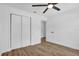 Comfortable bedroom includes a ceiling fan, wood floors, and a closet with sliding doors at 1301 Paradise Ln, Winter Park, FL 32792