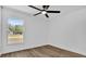 Well-lit bedroom with wood floors, a ceiling fan, and a large window at 1301 Paradise Ln, Winter Park, FL 32792