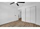 Spacious bedroom has a ceiling fan, wood floors, and a closet with sliding doors at 1301 Paradise Ln, Winter Park, FL 32792
