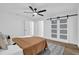 Bright bedroom with a modern ceiling fan, sliding glass doors, and light brown decor at 1301 Paradise Ln, Winter Park, FL 32792