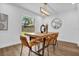 Bright dining room features wood floors, natural light, modern light fixture and stylish decor at 1301 Paradise Ln, Winter Park, FL 32792