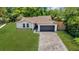 Inviting single-story home showcasing a well-manicured lawn and a convenient two-car garage at 1301 Paradise Ln, Winter Park, FL 32792