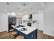Modern kitchen featuring a central island with bar seating, stainless appliances, and open layout at 1301 Paradise Ln, Winter Park, FL 32792