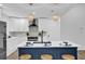 Modern kitchen featuring a central island, stainless steel appliances, and elegant pendant lights at 1301 Paradise Ln, Winter Park, FL 32792