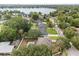 Aerial view of the home showcasing the backyard pool, landscaping, and nearby lake at 141 Dommerich Dr, Maitland, FL 32751