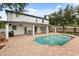Backyard view of the home featuring a pool with fountain features, brick pavers, and covered patio with seating at 141 Dommerich Dr, Maitland, FL 32751